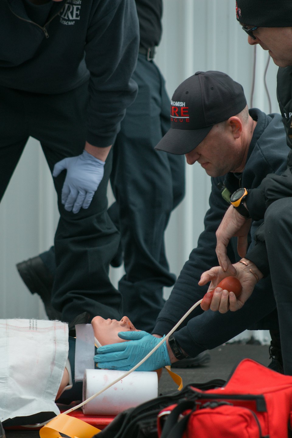 Trainees de primeros auxilios practican procedimientos médicos en un maniquí.